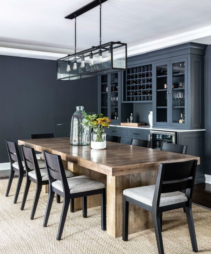 a dining room table surrounded by chairs and bottles