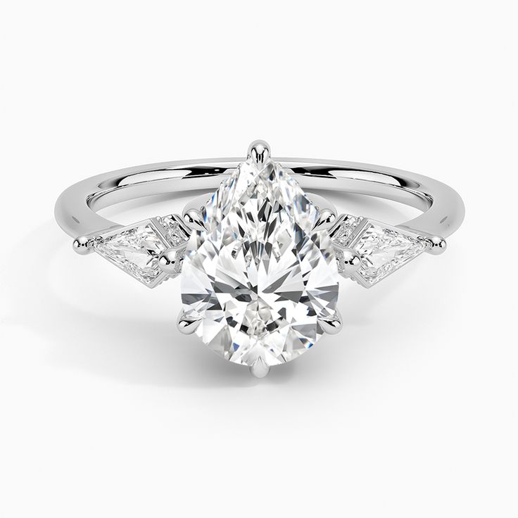 Pear Shaped Luxe Cometa Hidden Accent Diamond Engagement Ring - Platinum. Elegant and chic, this three stone ring features two kite-shaped diamond accents alongside a center gemstone cradled by lustrous claw prongs. Shimmering diamond accents are hidden along the inner edges of the setting for a pop of extra sparkle (2/5 total carat weight). White Moissanite Trillion Cut Diamond Ring, White Trillion Cut Moissanite Diamond Ring, Diamond White Marquise Diamond Ring With Accent Stones, Marquise Diamond White Ring With Accent Stones, Luxury Trillion-cut Diamond Ring With Center Stone, Luxury Diamond Ring With Trillion Cut Center Stone, Luxury Trillion Cut Diamond Ring With Center Stone, White Marquise Cut Three Stone Jewelry, Platinum Diamond Ring With Pear-shaped Accents