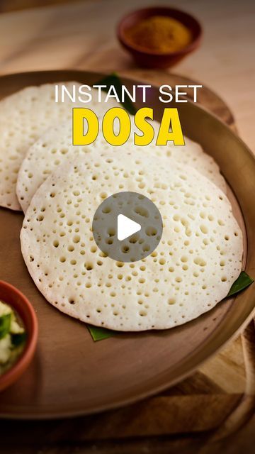 two pita breads sitting on top of a plate next to some dipping sauce