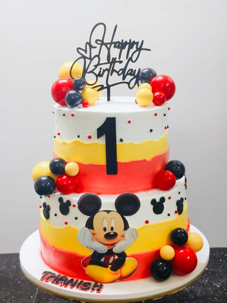 a mickey mouse birthday cake with the number one on it