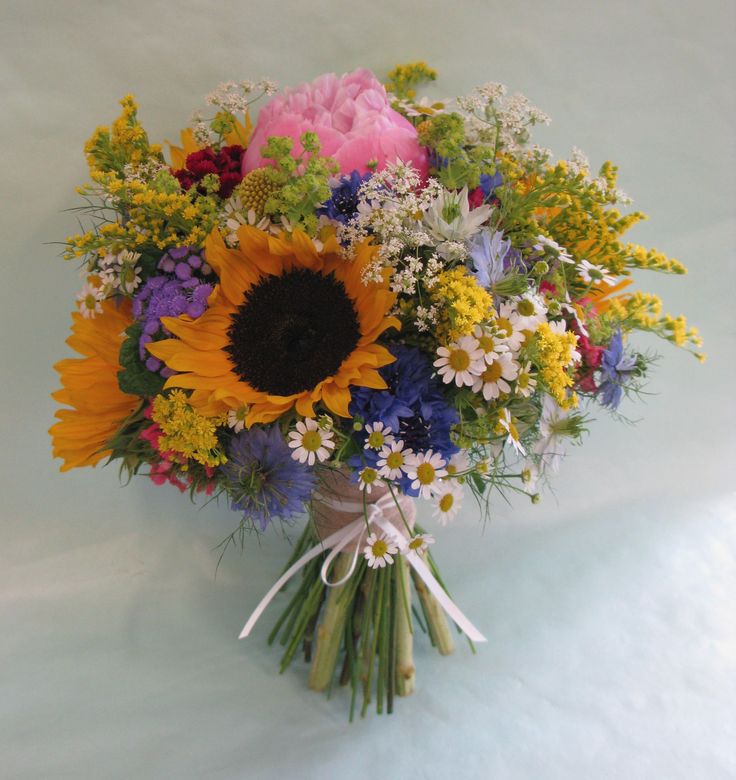 a bouquet of colorful flowers on a white surface