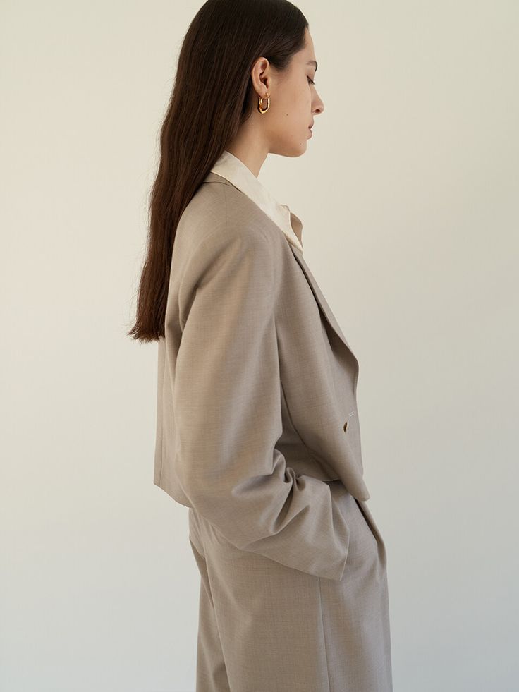 Editor's notesThis cropped suit jacket with a peaked collar feels nothing as heavy as your normal mid-length blazer. - Summer wool material- Cropped length jacket- Peaked collar, one-button detail- Shoulder pad- Fully lined- Set up with Layered belt wide trouser by MOHANMeasurements(in.)- Size: S, M- Shoulder: 17.52in / 18.11in    - Chest: 20.87in / 21.85in- Hem: 20.67in / 21.65in  - Sleeve: 24.41in / 24.61in- Length: 19.29in / 19.49in- Model size: 5' 6 / Bust: 31.5in / Waist: 23.5in / Hip: 34in and wearing a size SmallComposition & Care- 50% Polyester, 50% Wool- Dry clean onlyDesigner- by MOHAN Classic Wool Cropped Jacket For Work, Classic Cropped Formal Outerwear, Formal Single-breasted Cropped Jacket With Suit Collar, Tailored Wool Cropped Jacket For Office, Classic Double-breasted Cropped Jacket For Work, Classic Tailored Cropped Jacket With Lapel Collar, Formal Cropped Wool Jacket, Tailored Cropped Blazer For Business, Business Cropped Jacket With Notch Lapel And Hidden Buttons