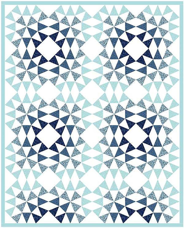 a blue and white quilt with triangles in the middle, on a light blue background