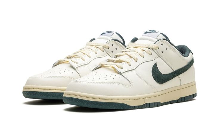 The Nike Dunk Low "Athletic Department - Deep Jungle" is a colorway of the retro basketball sneaker with a vintage college sports aesthetic.  The upper features a Sail leather construction with a Deep Jungle-colored suede Swoosh that matches the appearance of the heel tab with “Nike” embroidery.  Classic “Nike” detailing can be seen on the tongue.  More Deep Jungle accenting includes a green lining, and green rubber outsole underneath the rubber midsole.  A special “Nike Athletic Department” log Vintage Nike Shoes Aesthetic, Nike Shoes Green, Shoes Nike Dunks, Vintage Nike Shoes, Green Nike Shoes, Nike Embroidery, Deep Jungle, Sneakers Box, Kobe Shoes