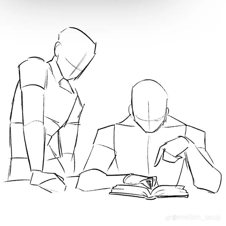 two people sitting at a table with an open book in front of them, one person is