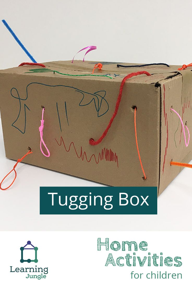 a cardboard box that has some string attached to it with the words tugging box