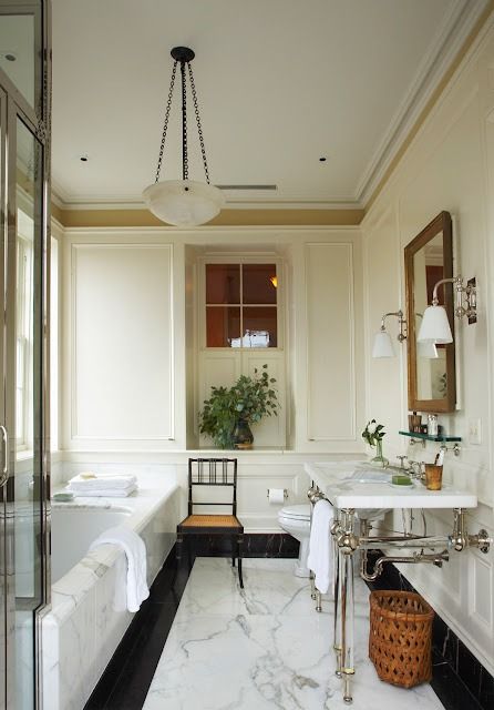 a bathroom with marble floors and white walls