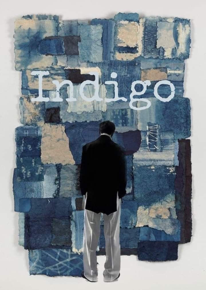 a man standing in front of a wall with the word indigoo written on it