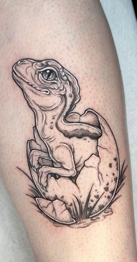 a black and white frog tattoo on the leg