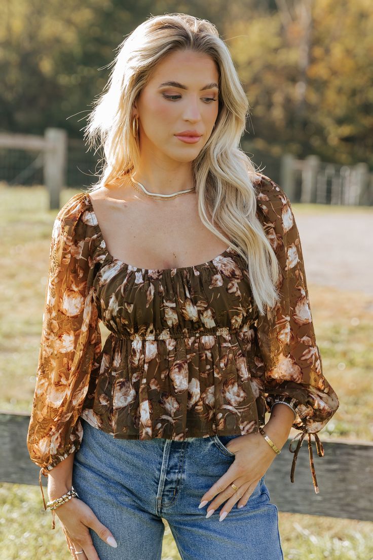 Embrace boho-chic vibes with the Olive Multi Floral Print Blouse, perfect for adding a touch of romance to any outfit! Features 3/4 sleeve length with delicate tie cuffs for a feminine flair. Designed with a square neckline and an elastic waistband for a flattering silhouette. The flowy hem creates a graceful movement, making it a versatile piece for day or night. Pair it with your favorite jeans or a skirt for an effortlessly stylish look. Chic Blouse For Gatherings, Flowy Lantern Sleeve Peasant Top For Summer, Long Sleeve Peasant Top For Summer Gatherings, Fitted Blouse For Spring Gatherings, Spring Floral Print Blouse For Gatherings, Summer Flowy Peasant Top With Blouson Sleeves, Floral Print Blouse For Spring Gatherings, Summer Peasant Top With Blouson Sleeves, Brown Square Neck Top For Spring