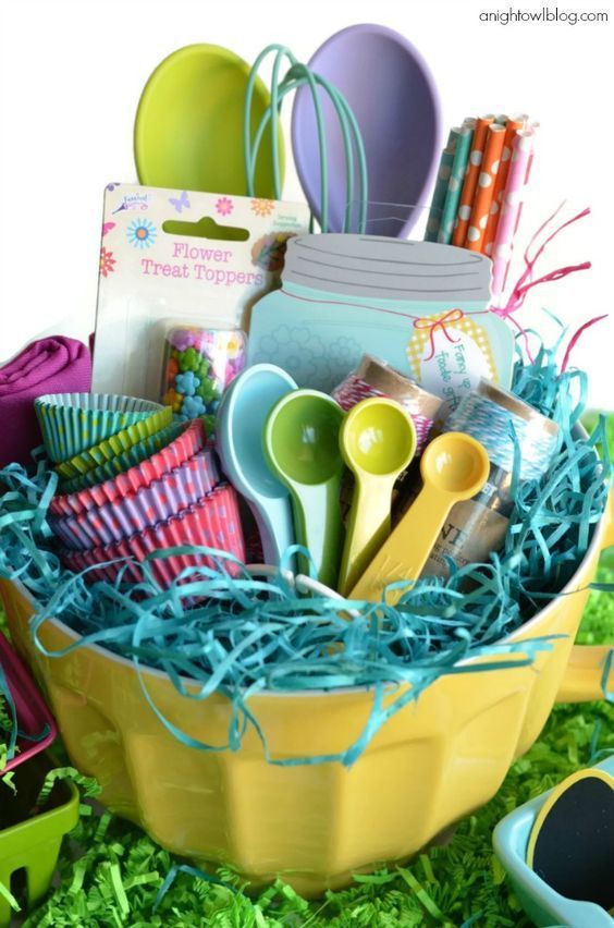 an easter basket filled with eggs and colorful utensils