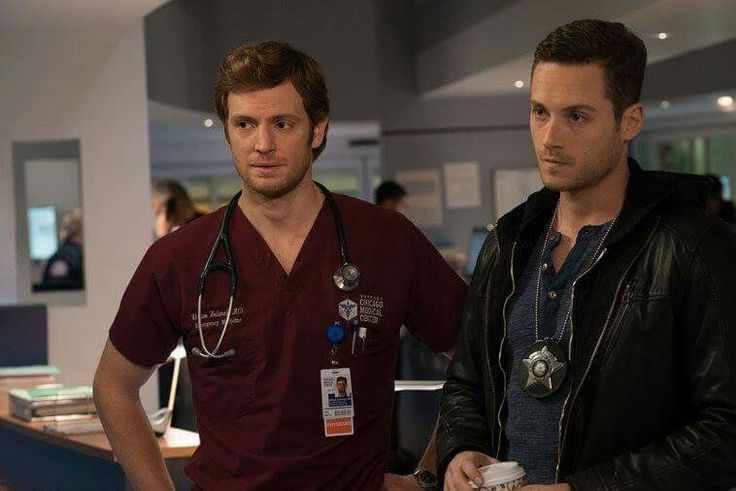 two men in scrubs standing next to each other