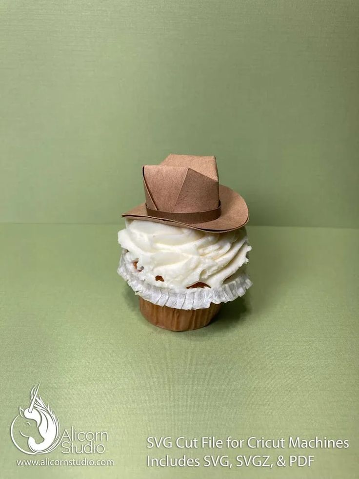 a cupcake with white frosting and a brown hat on top