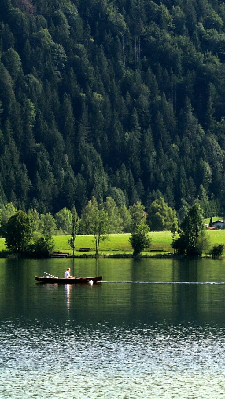 two people in a small boat on a lake