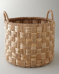 a woven basket is shown with handles on the top and bottom, which are made from natural materials