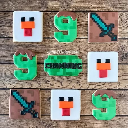 decorated cookies are arranged in the shape of ducks and swords, with numbers on them