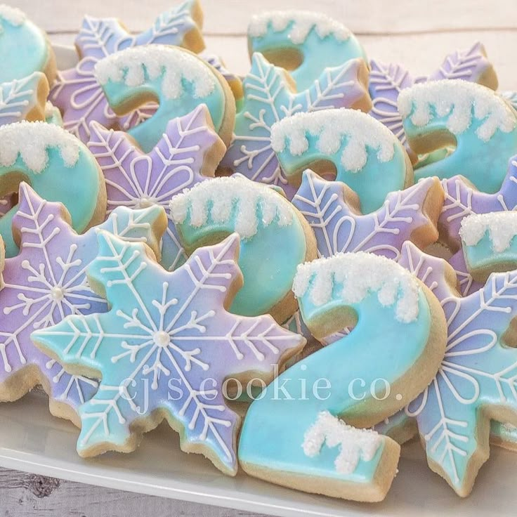 cookies decorated with frosting and icing are on a plate