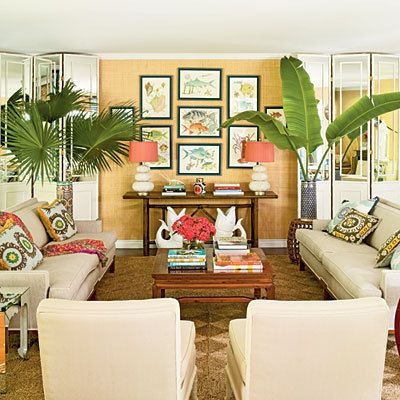 a living room filled with furniture and lots of plants on top of the tables in front of them