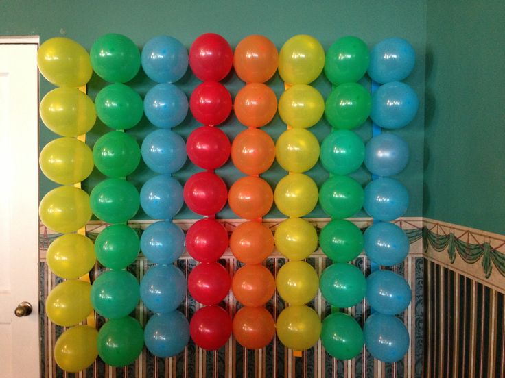 there is a bunch of balloons hanging on the wall