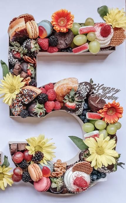 the letter e is made up of fruits and flowers