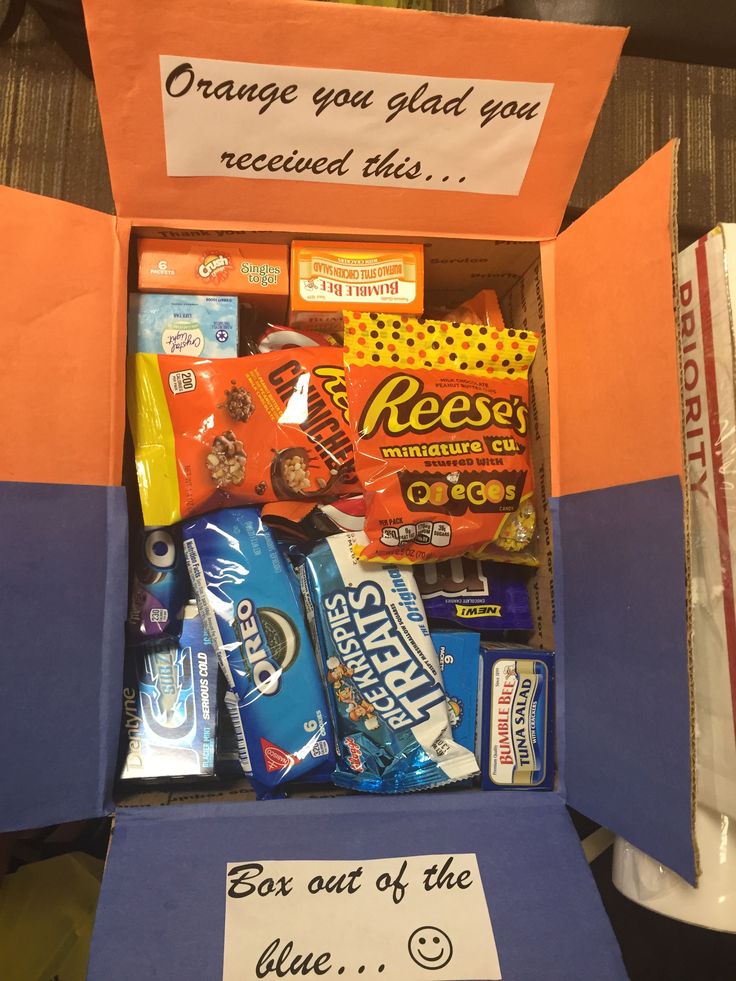 an orange box filled with candy and snacks