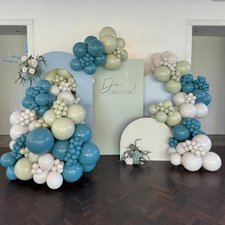 balloons and flowers are arranged in the shape of an arch for a wedding ceremony decoration