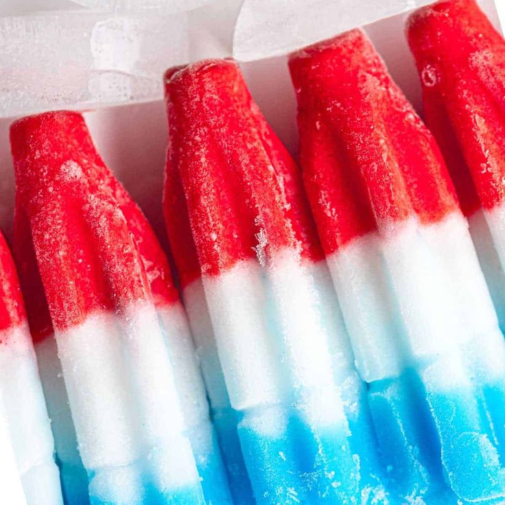 four red, white and blue toothbrushes in a box