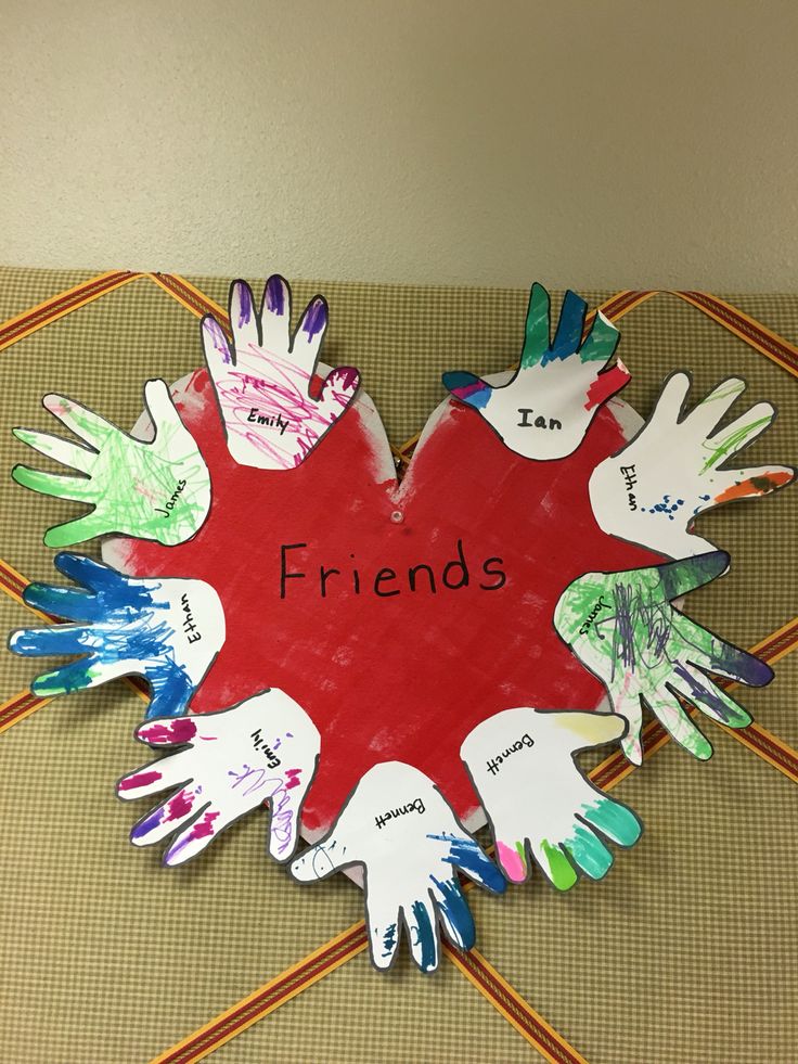 a group of children's handprints arranged in the shape of a heart