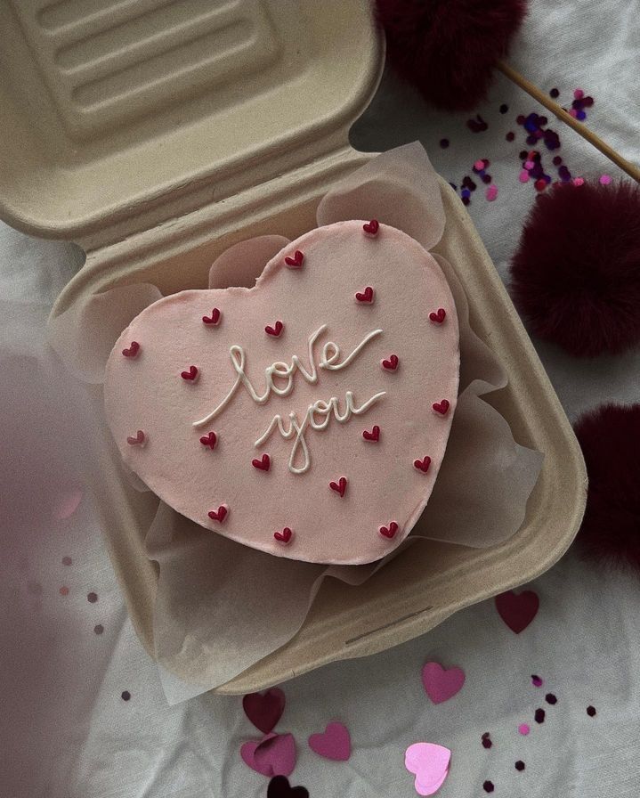 a heart shaped cake in a box with the words i love you written on it