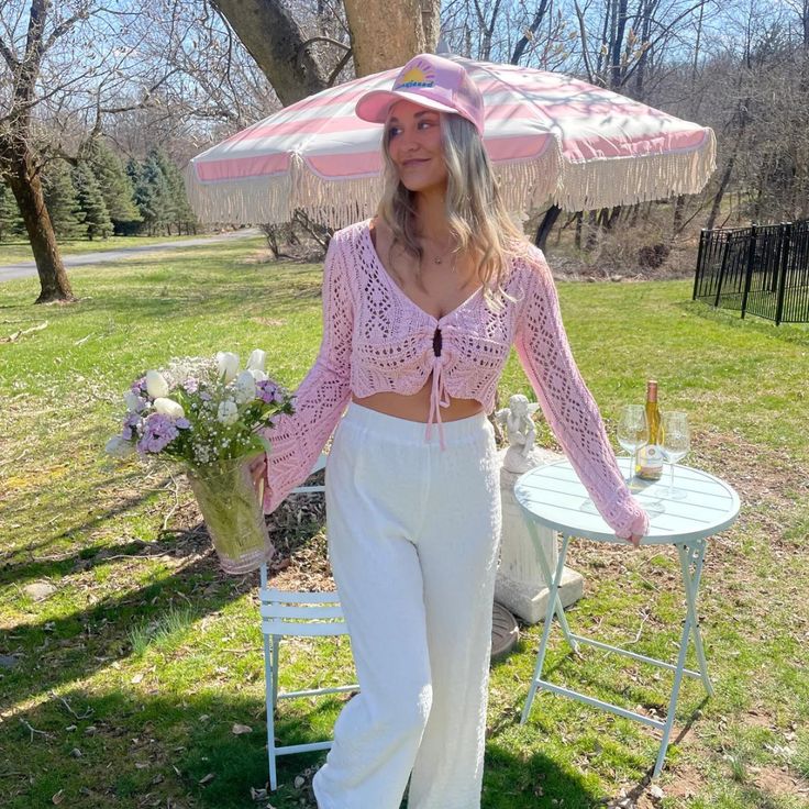 Introducing the newest addition to our bestselling collection - the Poolside Crochet Top NOW in a dreamy pale pink hue! This top features a cropped fit that's perfect for pairing with high-waisted bottoms, and a front adjustable tie that allows for a customizable fit. The full long sleeve crochet design adds a touch of bohemian elegance to any outfit. Long Sleeve Cover Up Crop Top, Feminine Cropped Top For Vacation, Feminine Crop Top For Beach In Spring, Feminine Crop Top For Spring Beach Days, Feminine Spring Crop Top For Beach, Pink Cropped Crop Top For Spring, Spring Vacation High Waist Crop Top, High Waist Crop Top For Spring Vacation, Pink Cropped Top For Vacation