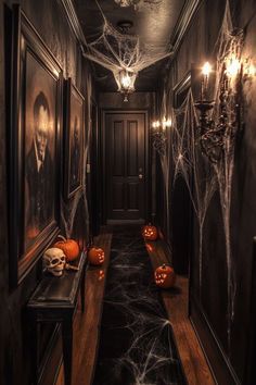 a hallway decorated for halloween with pumpkins and spider web