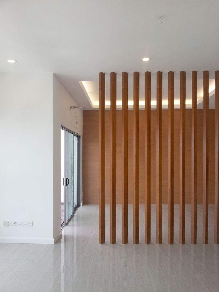 an empty room with wooden slats on the wall