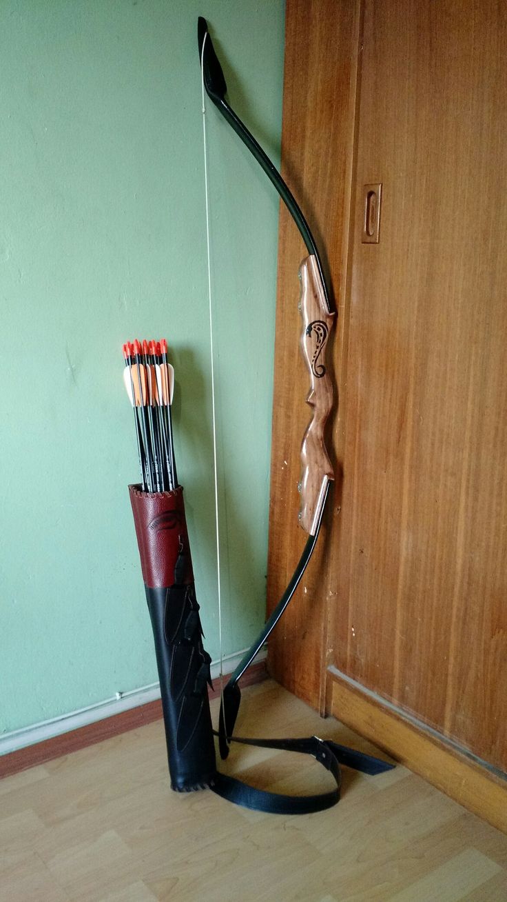 a bow and arrow in the corner of a room