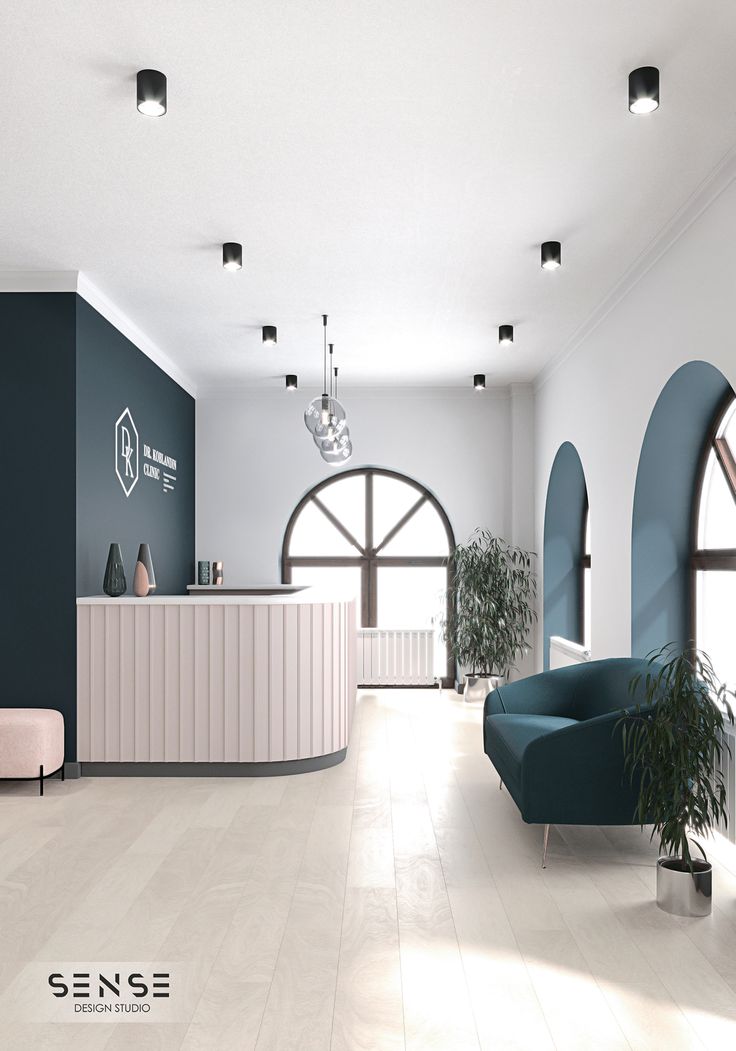 an office lobby with blue and white walls, arched windows, and a reception counter