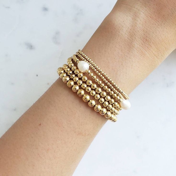 Gold Bead Bracelet, Beaded Bracelet, Gold Bracelet Stack, Stacking Bracelet 2mm 3mm 4mm, Dainty Bracelet Classic gold bead bracelet is a perfect addition to a dainty stack this spring/summer season. The beads are strung on a premium stretch cord. SOLD BY ONE BRACELET ITEMS DETAILS: Water Resistant -Nickel-free - Allergy-free - - High-Quality 18K gold plated brass beads made to last - round bead size: 2mm, 3mm, 4mm, 5mm -Freshwater pearls ( due they are natural pearls may vary the size and shape) Stackable Round Bead Pearl Bracelet For Everyday, Stackable Pearl Bracelet With Round Beads, Minimalist Stackable Bracelets With Round Beads, Adjustable Stackable Pearl Bracelet With Round Beads, Stackable Adjustable Pearl Bracelet With Round Beads, Dainty Stackable Pearl Bracelet With Round Beads, Dainty Stackable Round Bead Bracelets, Dainty Bracelet With Spacer And Round Beads, Dainty Stackable Beaded Bangle Bracelets