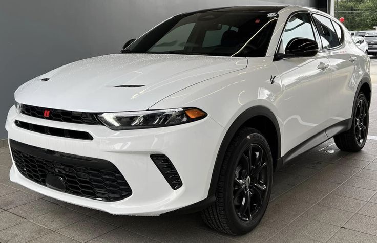 a white car is parked in a showroom