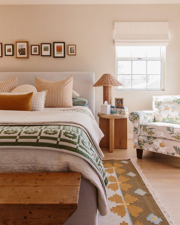 a bed room with a neatly made bed and a chair