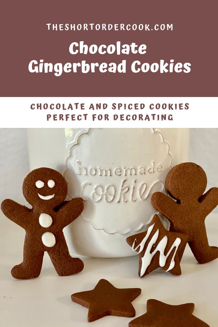 chocolate gingerbread cookies with white frosting and decorated in the shape of two people