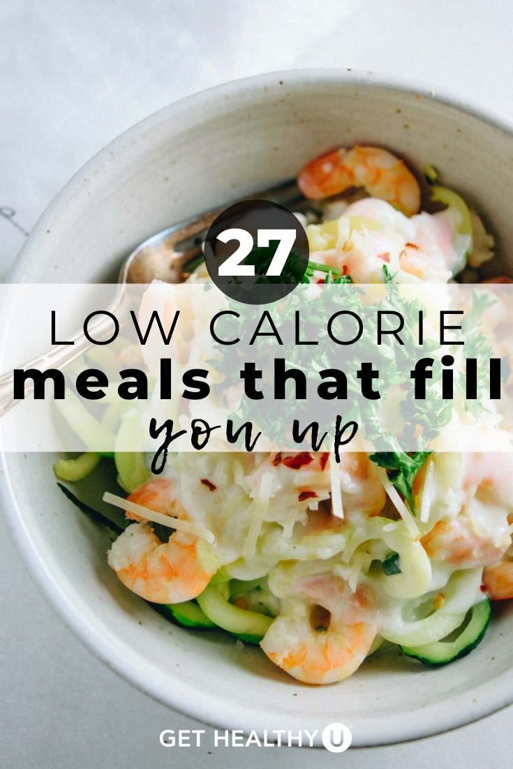 a white bowl filled with shrimp and veggies on top of a marble counter