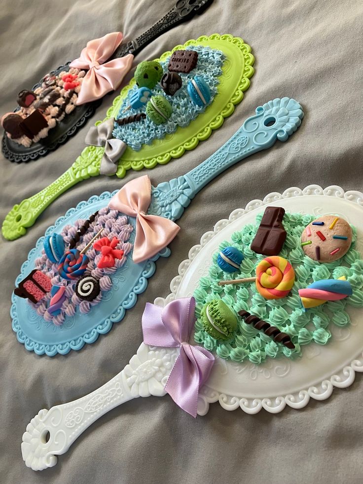 three decorated spoons sitting on top of a bed