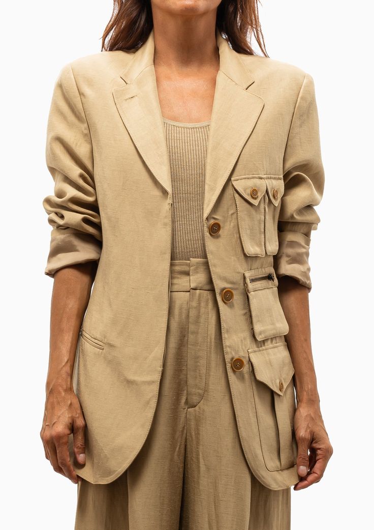 This new 3 button blazer silhouette from Smythe is oversized and features detailed cargo pockets and a hidden placket. We plan to live in this blazer. Pair with the matching Cropped Vest in Khaki and Pleated Trouser Pants in Khaki for a complete look. Or for a more casual look, layer over sundresses or jean shorts. 52% Rayon, 48% Linen | Lining: 100% Cupro Rayon that is ecotoxicity-free and entirely biodegradable. Dry Clean Only Model is 5’8” and wearing a size XS. Runs true to size for an overs Luxury Khaki Utility Jacket With Button Closure, Luxury Oversized Blazer For Workwear, Luxury Khaki Outerwear For Business Casual, Luxury Business Casual Khaki Outerwear, Luxury Khaki Outerwear For Work, Luxury Khaki Outerwear For Office, Luxury Khaki Outerwear For Winter, Cargo Pant Heels Blzer, Luxury Oversized Chic Blazer