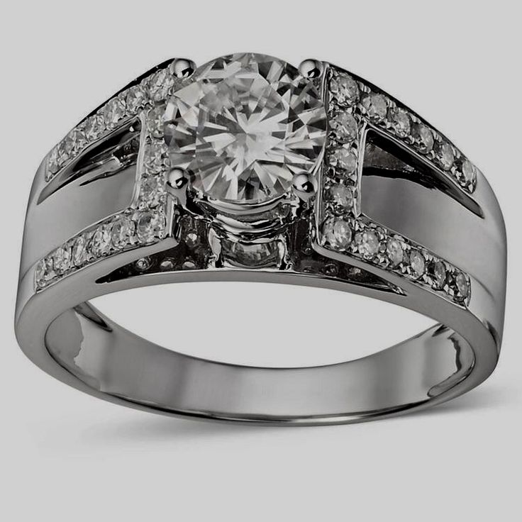 a white gold ring with diamonds on the sides and a center stone in the middle