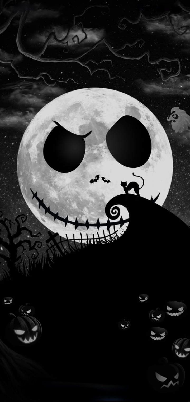 a black and white image of a jack - o'- lantern with the moon in the background