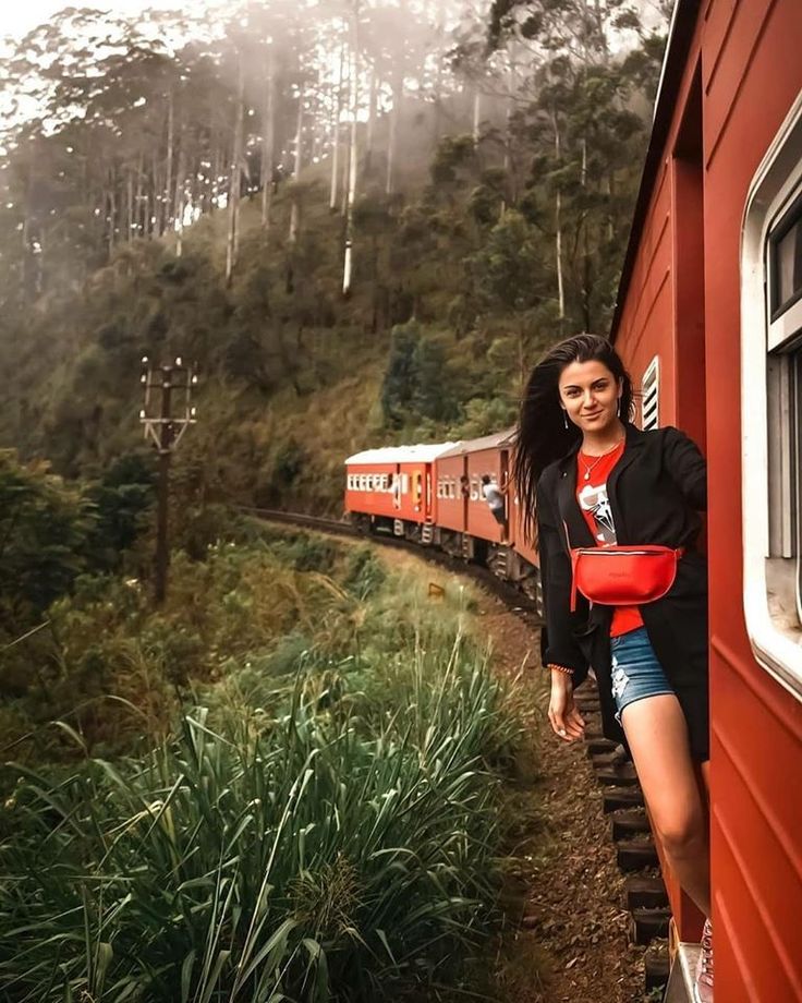 a woman leaning against the side of a train