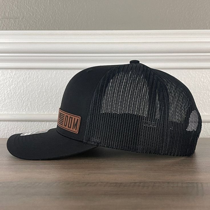 FREEDOM Flag Side Leather Patch Hat Black/Black Specifications: 🧢 SnapBack Trucker Hat; adjustable for the perfect fit 🎩 Cotton/polyester blend for comfort 📏 One size fits most 🏷️ Expertly laser engraved leatherette patch design 📦 Ships in 2 to 3 business days from our Orlando Studio Care Instructions: 🚫 Do not wash; spot clean only Please Note: 🌈 Colors may vary from photos based on your viewing screen. Orlando Studios, Leather Patch Hat, Engraved Tumblers, Patch Hat, Patch Design, Leather Patches, Holiday Collection, Trinidad And Tobago, Laser Engraved