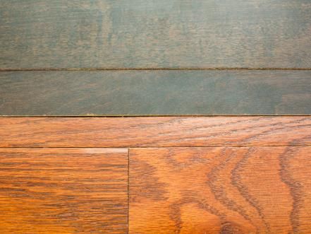 closeup of wood flooring showing the grains and stain that is applied to it