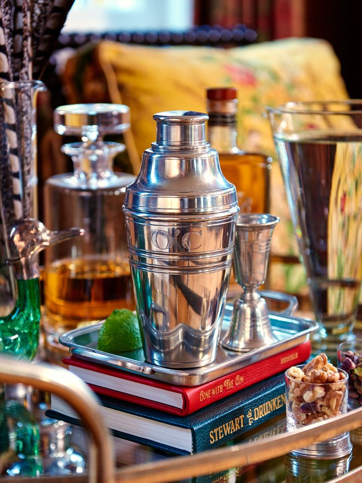 an assortment of silver cups and glasses on a tray