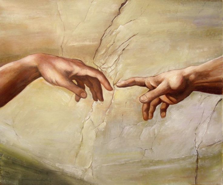 two hands touching each other in front of a painting