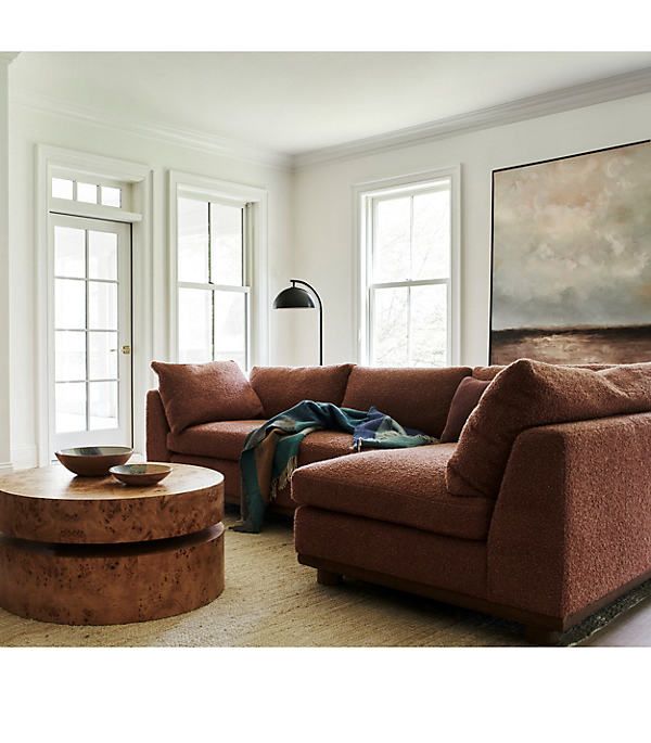 a living room with two couches and a coffee table in front of the window