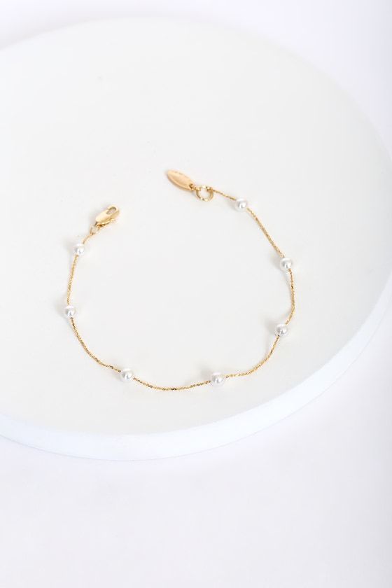 Lulus Exclusive! No matter the day or place, look your absolute best with the Lulus Keep it Stunning 14KT Gold and Pearl Bracelet! This stunning bracelet features a shiny 14KT gold plated chain with circular freshwater pearl beads. Pair with anything from a casual tee to a LBD! Lobster clasp closure. Bracelet measures 8" long. 14KT gold plated brass and freshwater pearl. Imported. Lulus | Keep it Stunning 14KT Gold and Pearl Bracelet. Elegant Metal Charm Bracelet With Delicate Chain, Dainty Gold-tone Metal Bracelets, Dainty Gold Beaded Bracelets With Chain, Delicate Metal Bracelets For Everyday Wear, Delicate Metal Bracelet For Everyday Wear, Dainty Gold Metal Bracelet For Formal Occasions, Dainty Chain Bracelets For Wedding, Dainty Gold Bracelets With Pearl Chain, Dainty Pearl Chain Bracelets For Party